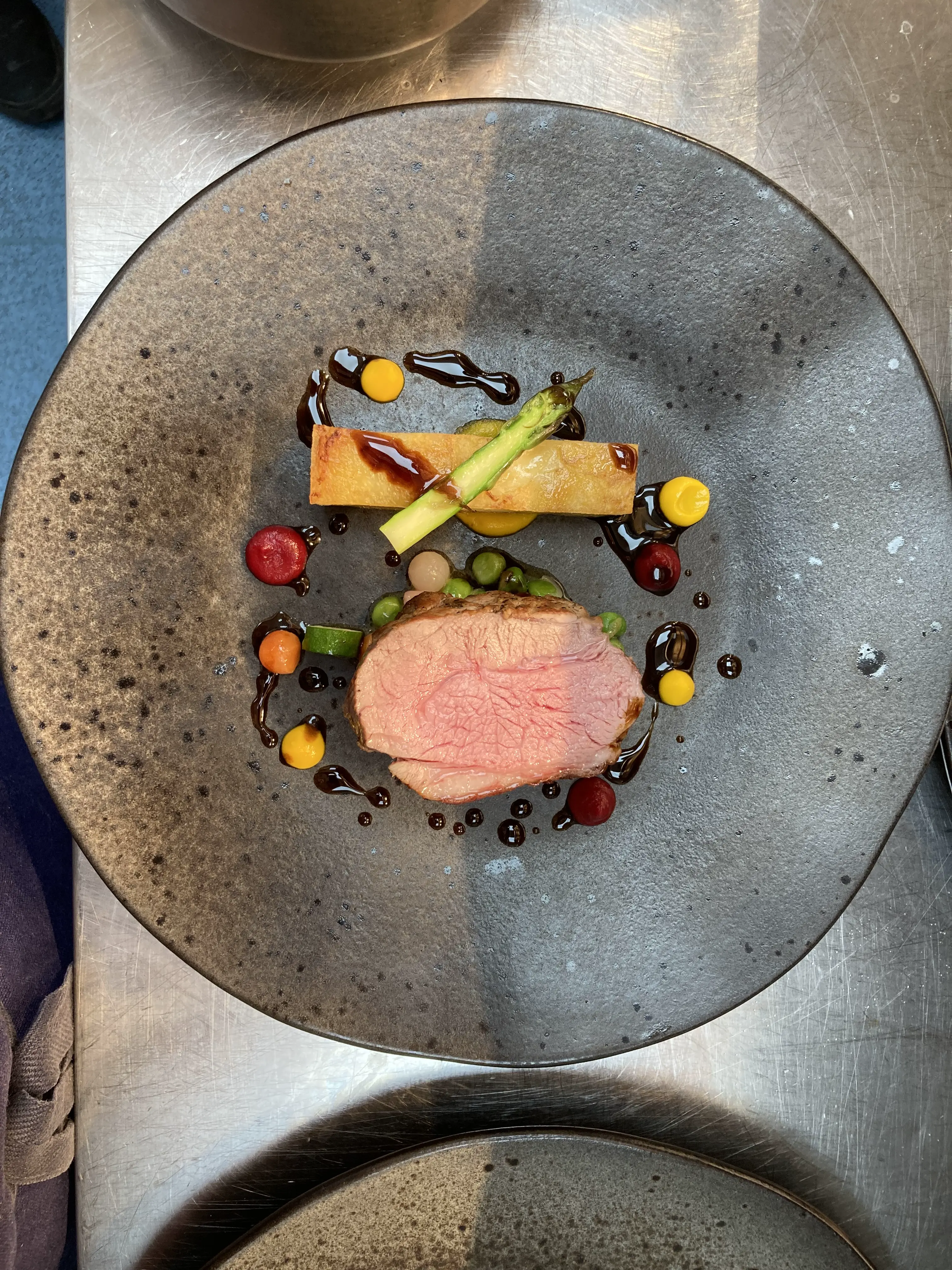 Luxury villa dining setup with chef preparing